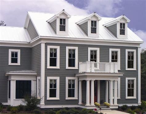 grey house with white metal roof|dark grey brick house.